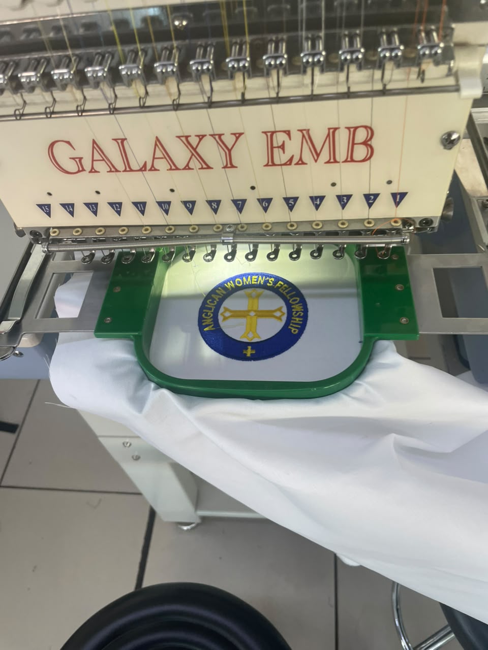 An embroidery machine stitching a detailed custom badge