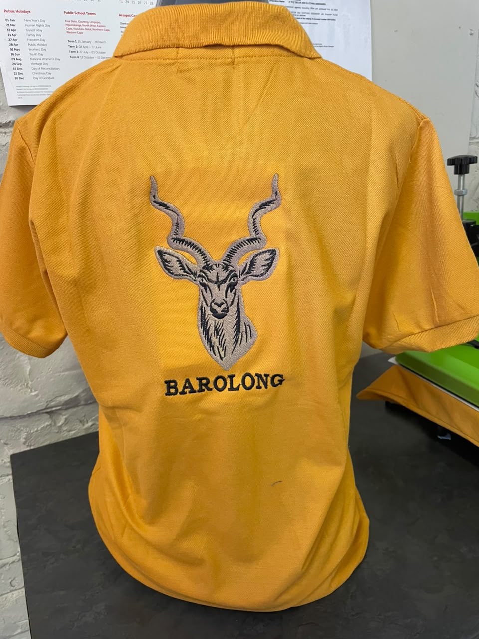 Detailed antelope embroidery on a golf shirt
